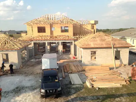 Sprawling single-story estate home framed and sheathed wing to wing, work van out front