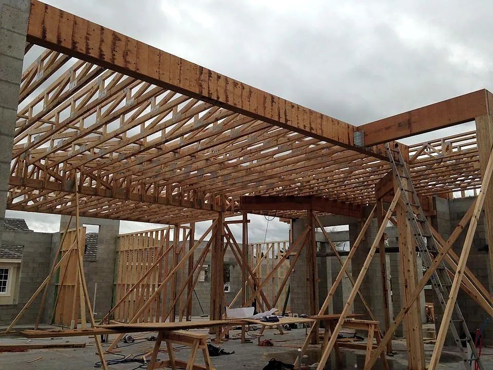 Roof truss grid framed over interior stud walls
